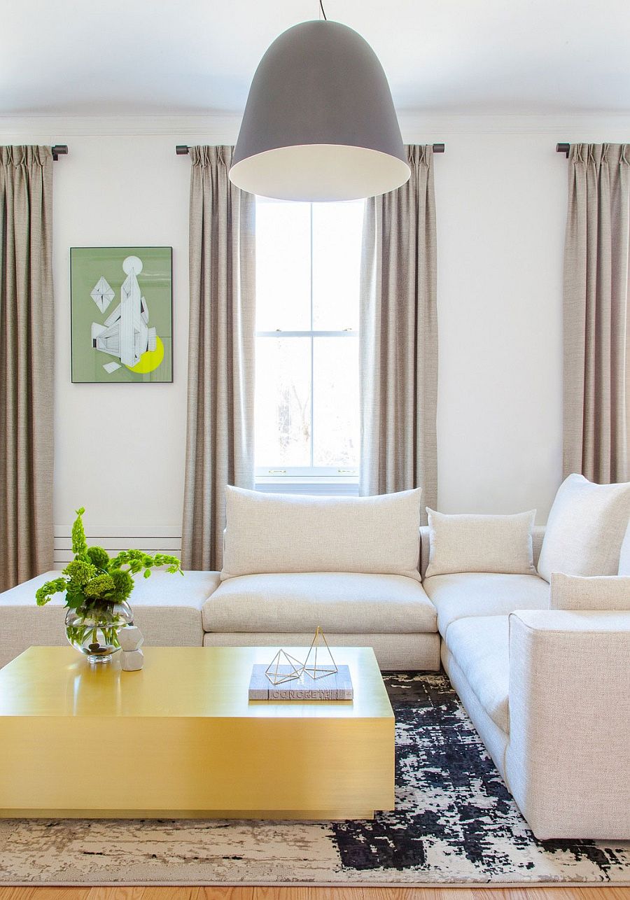 Custom-brass-coffee-table-and-oversized-pendant-in-the-Chelsea-apartment-living-room.jpg